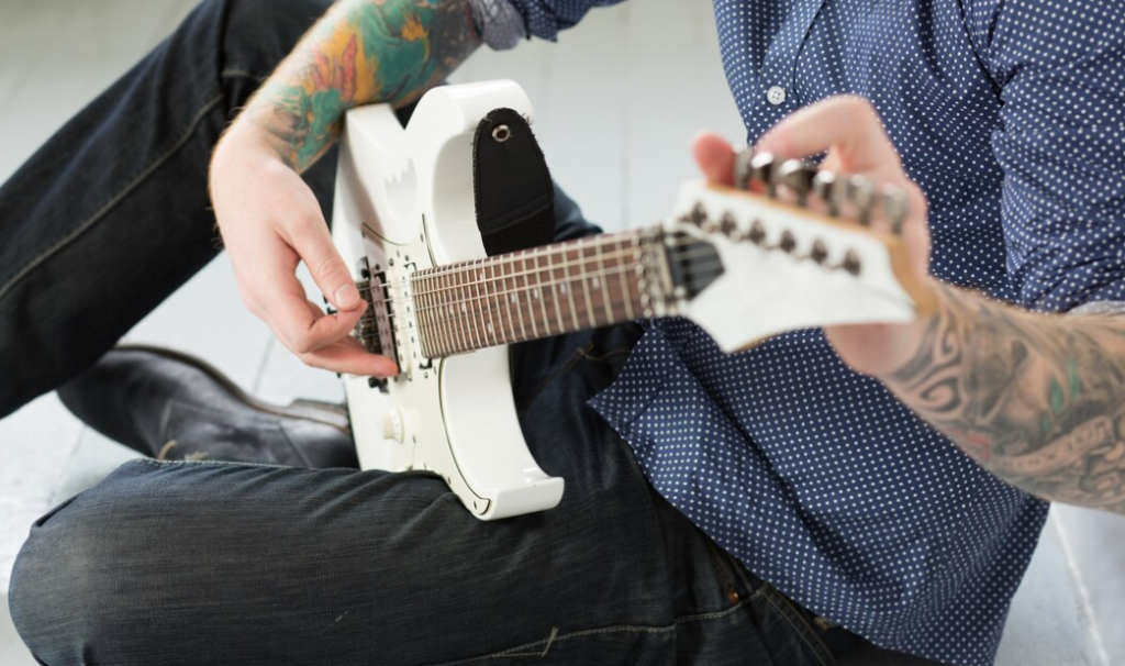 How to Hold a Guitar Correctly: Posture and Technique for Beginners ...